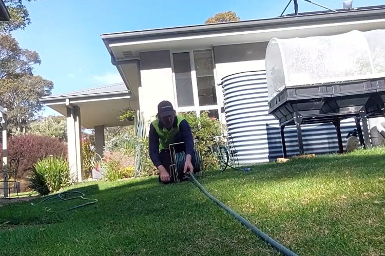 
As the sun sets, the ulladulla downpipe cleaner is coiling his hose after a successful day.