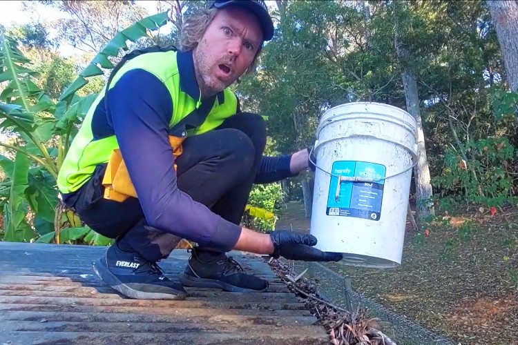 ulladulla gutter cleaning is showing the importance of having a bucket during  gutter cleaning